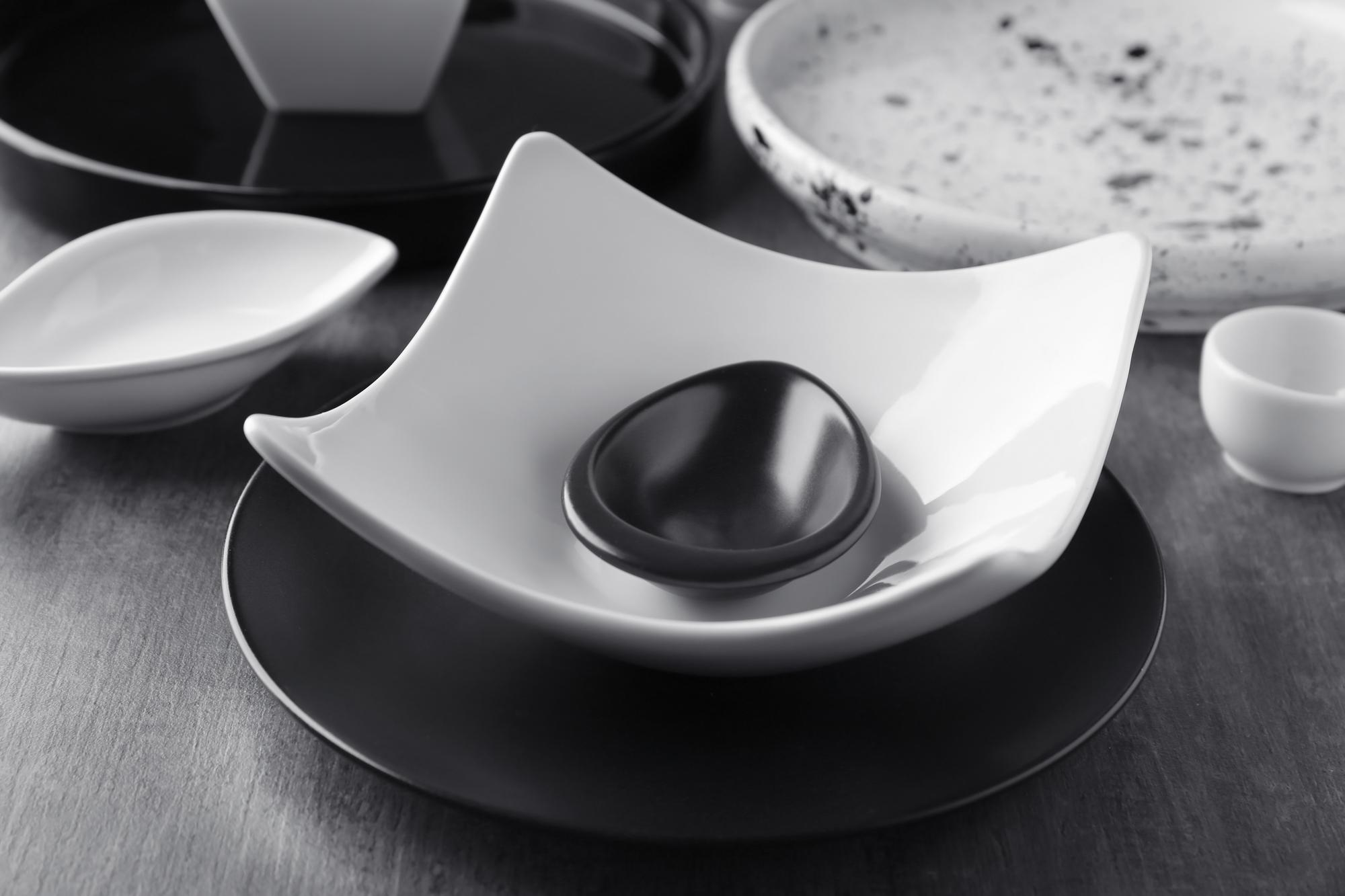 Close-up of precision tools and plated dish on a white workspace